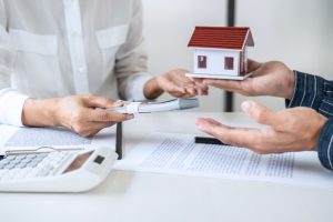 Real estate broker agent consult to customer to decision making sign insurance form and sending house model to client after approve, home model mortgage loan offer for and house insurance Real estate broker agent consult to customer to decision making sign insurance form and sending house model to client after approve, home model mortgage loan offer for and house insurance.